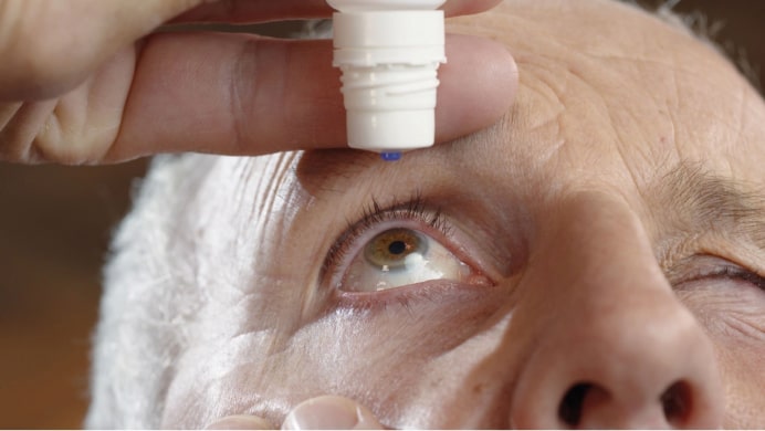 Man applying eye-drops