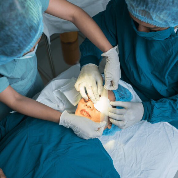 Surgeons performing eye surgery