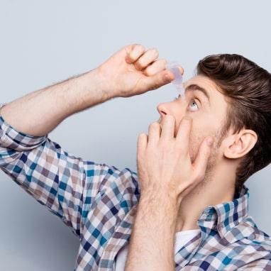 Man applying eye-drops