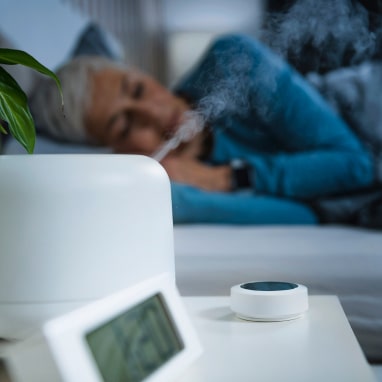 Woman lying down and using dehumidifier