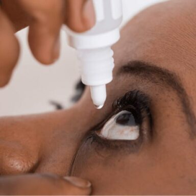Woman applying eye-drops