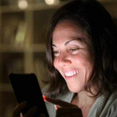 Woman smiling holding laptop