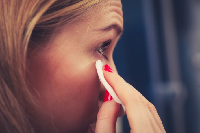 Woman wiping eye