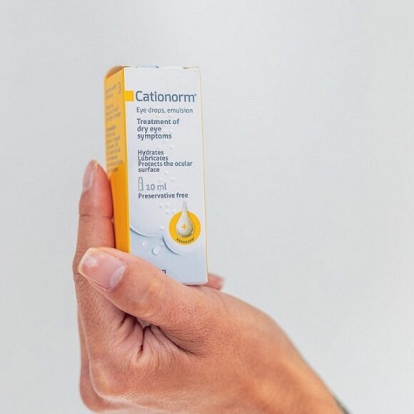 Image shows Cationorm eye drops pack being held in person's hand