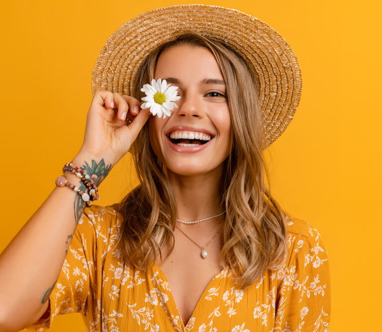 Lady holding a daisy