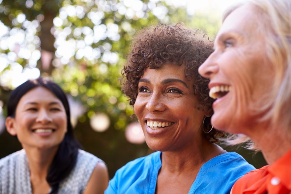 Three diverse women smiling