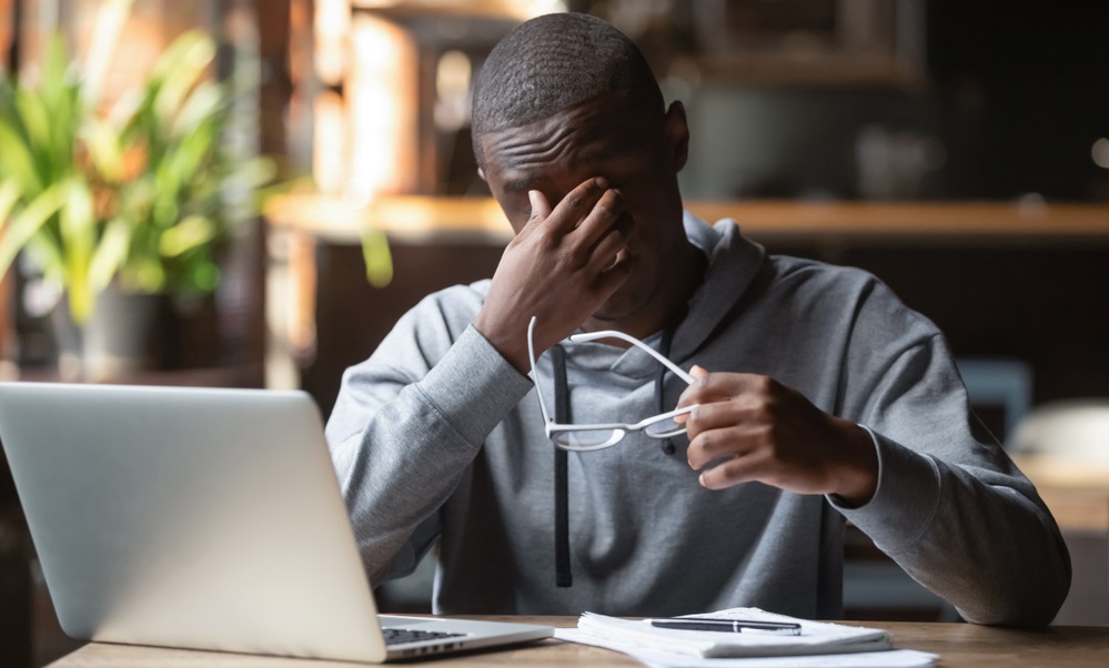 Man suffering from dry eye after using a laptop