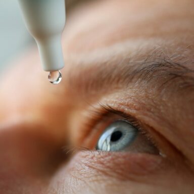 Man Applying Eye Drops