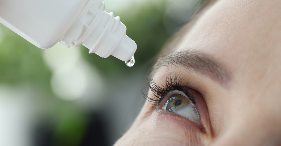 Lady applying eye drops